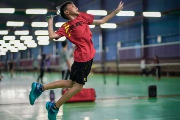 female badminton player smash